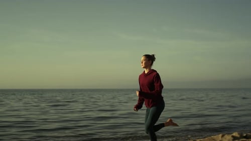 Attractive Girl Runner Training on Sandy Beach Evening Time. Sporty Woman Running