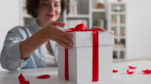 Woman Opens Gift Box Revealing Lingerie Bra