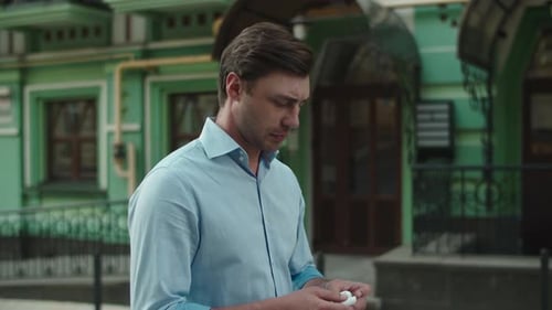 Man walking and putting in wireless headphones