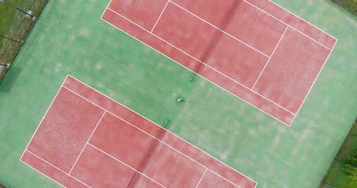 Top View Of Red Tennis Courts On Green Field. aerial drone, screwdriver shot