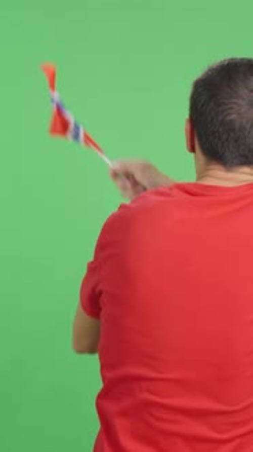 Rear View of a Man Waving a Norwegian Pennant