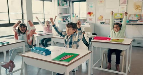 Children, happy and and raise hands in classroom celebration, education and learning quiz in school