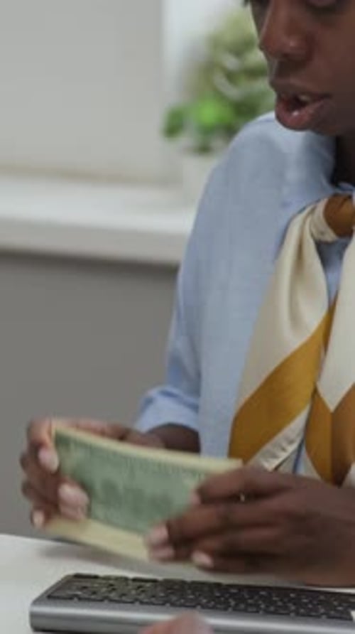 Employee Using Counting Device for Banknotes at Bank Desk