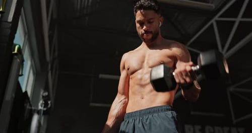 Music, dumbbell and man exercise for muscle, wellness and body health in gym