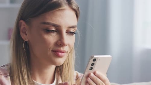 Smiling Woman Using Smartphone Close Up Indoors