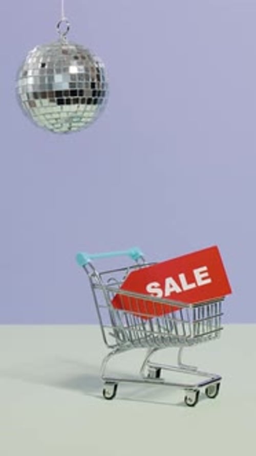 Shopping Cart with Disco Ball Advertising a Sale