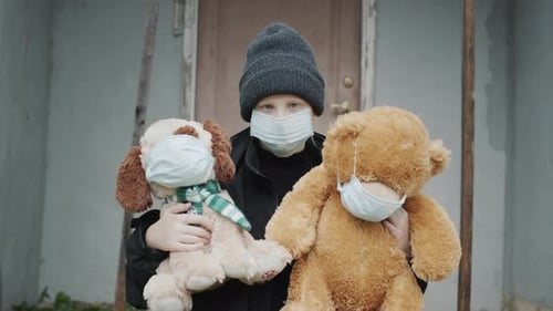 A Child in a Mask Keeps His Toys on Which Masks are Worn On the Doorstep of your House Depression