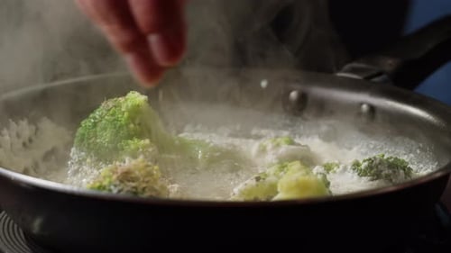 Broccoli Cauliflowers Cooking in a Creamy Sauce in Pan Closeup Green Vegetables Boiling in a Pan