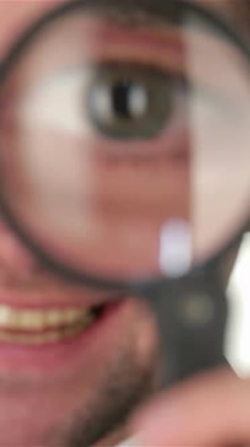 Businessman Examining Details Through a Magnifying Glass