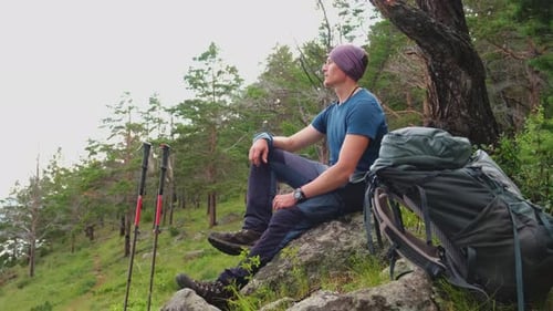 Hiking Climbing Cliff Adventure Backpacker Man Resting After Hiking Looking at Beautiful View Hiker