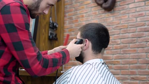 Barber Giving Haircut to Client in Barber Shop