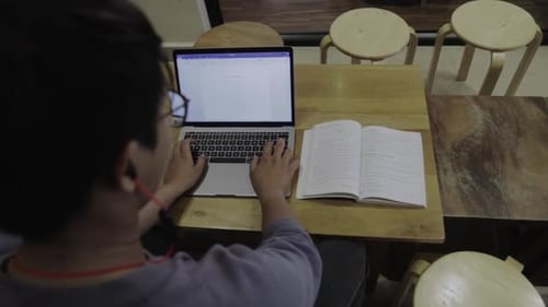 A college student preparing his document before exam.