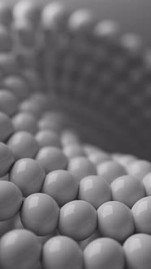 Looped animation of a close-up Mobius shape made of glossy white spheres.