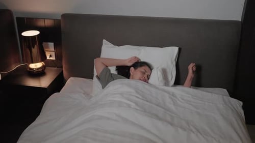Dark Haired Woman Sleeping Soundly in Bed