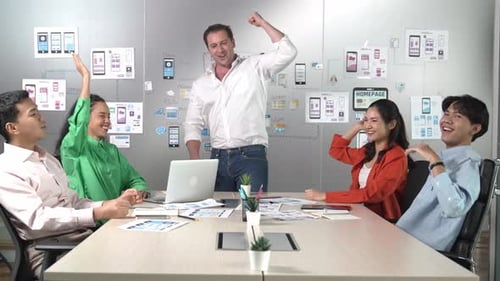 Diverse Team Celebrates Business Success in Modern Office