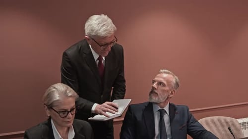 Adults in Suits Working at a Meeting