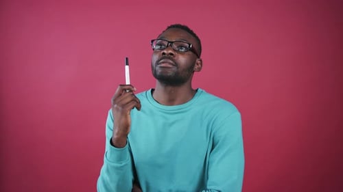 Bearded Man Ponders Idea With Pen in Hand