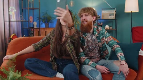 Young Couple Video Calling on Couch at Home