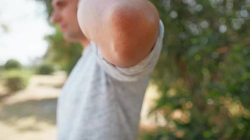 Young Adult Male Moving Arm Outdoors