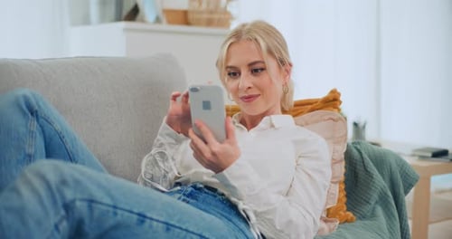 Woman Relaxing on Couch, Using Smartphone