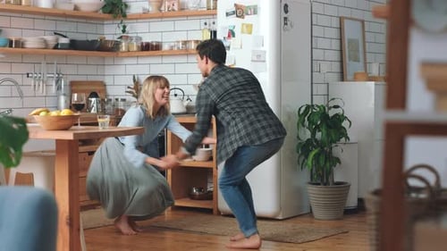 Young Couple Dancing Happily in Their Kitchen