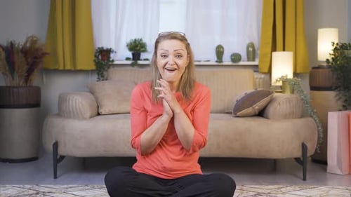 Enthusiastic Woman Gesturing While Sitting in Living Room