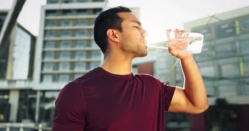 Man, drinking water and fitness in city for exercise, running break and health
