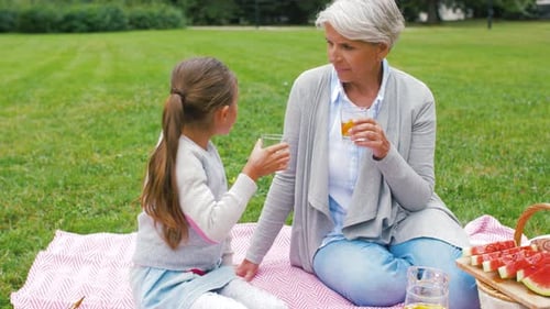 Grandmother and Granddaughter Enjoy Picnic in the Park