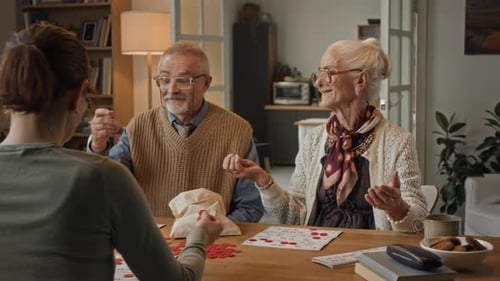 Senior Couple Enjoying Game of Bingo with Daughter