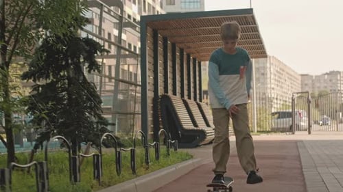 Caucasian Preteen Boy Riding Skateboard Outdoors