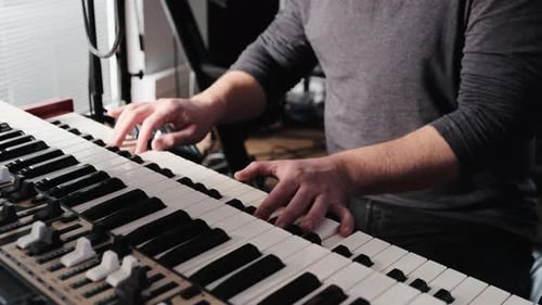 Man Plays Keyboard Electronic Piano Instrument