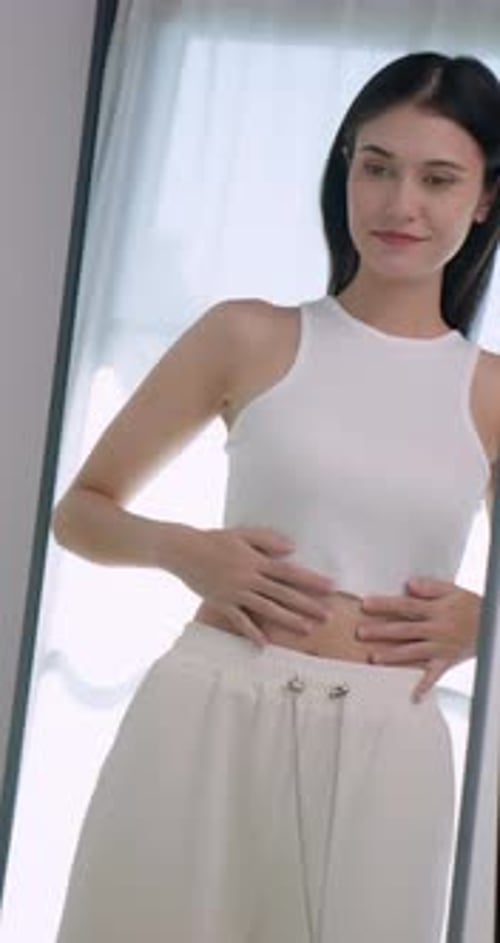 Young Woman Posing in Front of Mirror