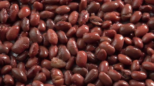 Canned red kidney beans rotating background top view. Organic steamed beans. Pickled beans