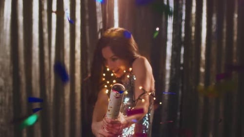 Woman Celebrates with Confetti Cannon at Party