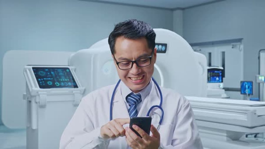 Close Up Of Asian Male Doctor Using Smartphone With MRI Machine ...