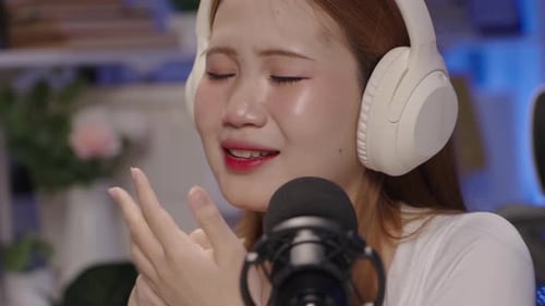 closeup of a female talking on the microphone during a podcast.