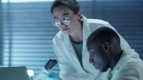 Multiethnic Scientists Working on Laptop in Laboratory