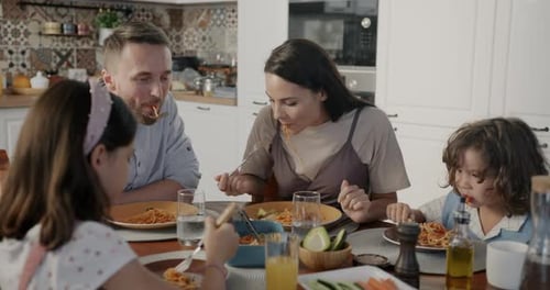 Family Enjoying Spaghetti Dinner Together at Home