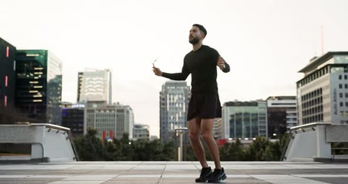 City, training rope and man jump, exercise and cardio endurance, commitment and morning challenge