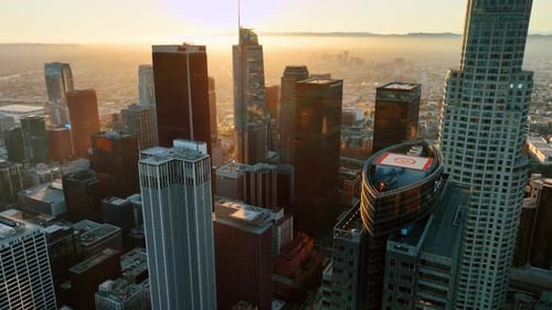 Descend in the modern downtown of Los Angeles, California, USA. City covered with fog at backdrop.