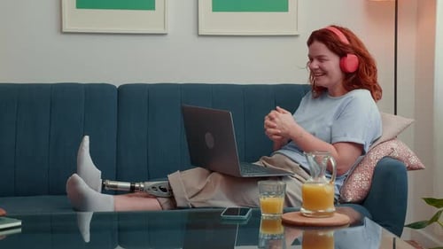 Woman with Prosthetic Leg Working on Laptop