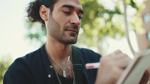 Young Adult Man Creating Art Outdoors in Urban Setting