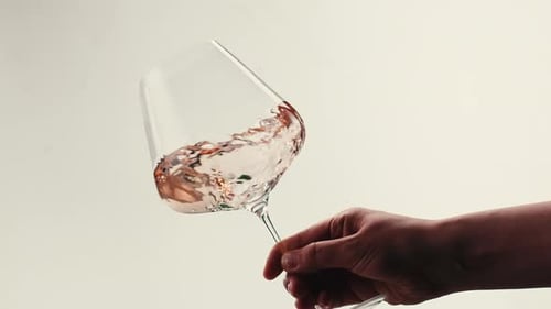 Orange or White Wine Bottle and Glass Against a Sunset in a Peaceful Vineyard Pouring of Ecological