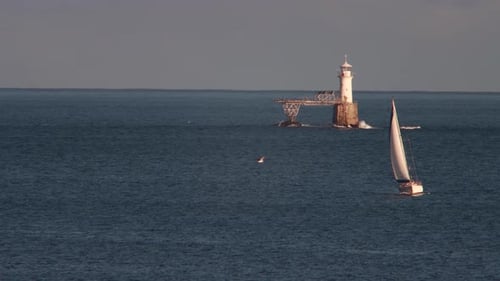 lighthouse and yacht in the bay