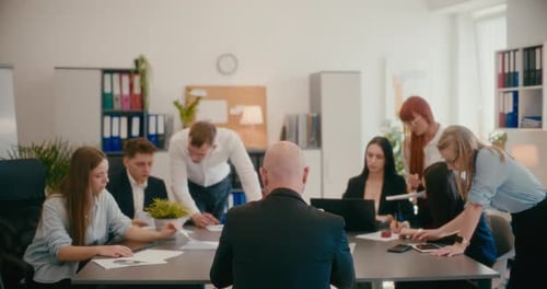 Manager with Employees Working in Office