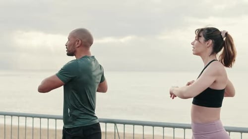Nahaufnahme einiger Athleten, die synchron Körperdrehungen ausführen und sich vor dem Straßentraining aufwärmen