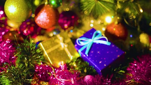 Shiny Christmas Ornaments and Gifts Underneath Tree