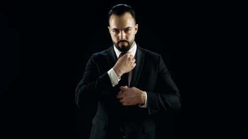 Man in Suit Showing King of Spades Card