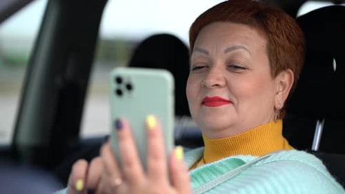 Woman Uses Cell Phone in the Car