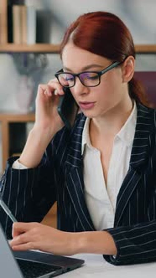 Professional Woman on Phone Working at Desk